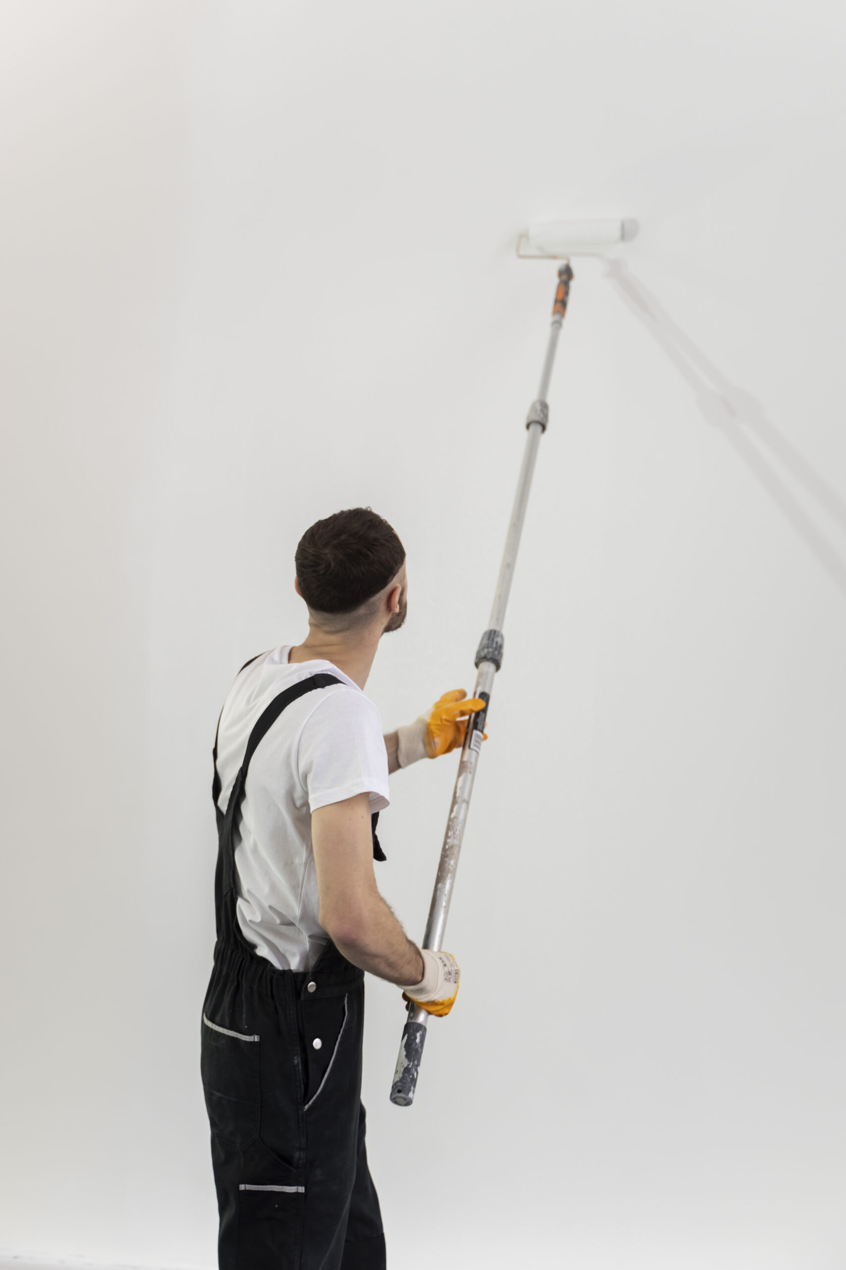 medium-shot-young-man-painting-wall